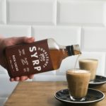 doubleshot_man_holding_rich_cacao_coffee_syrup
