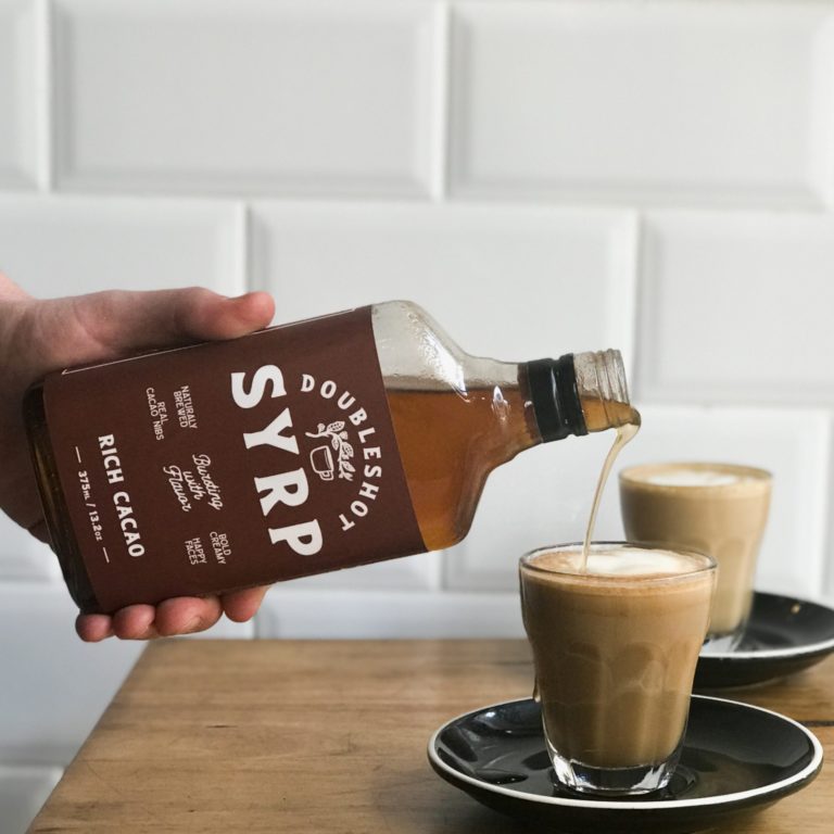 doubleshot_man_holding_rich_cacao_coffee_syrup
